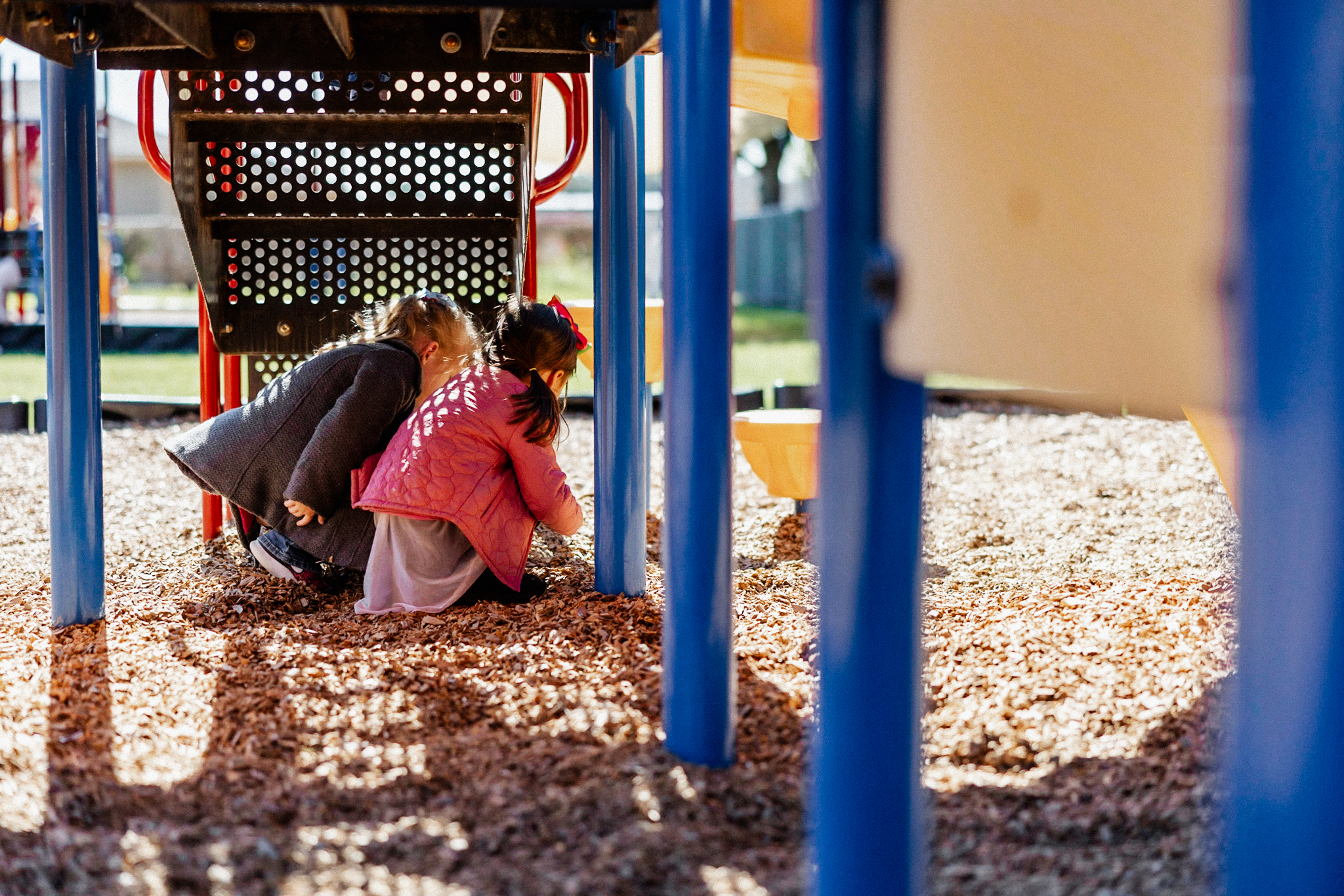 Two girls playing on preschool's playground