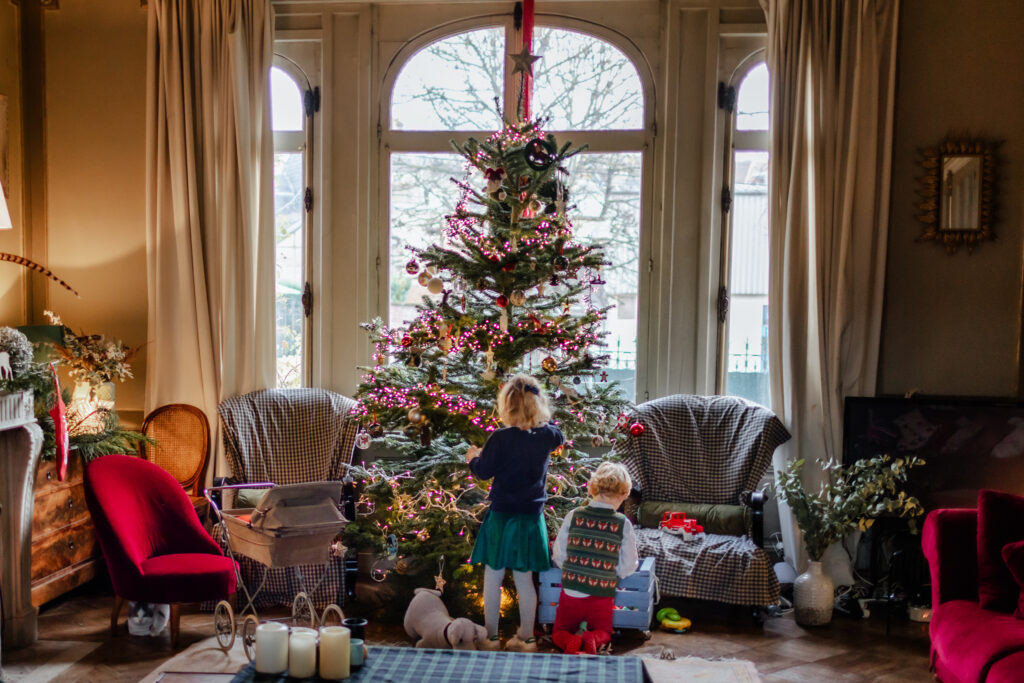 Little boy and girl decorating a christmas tree