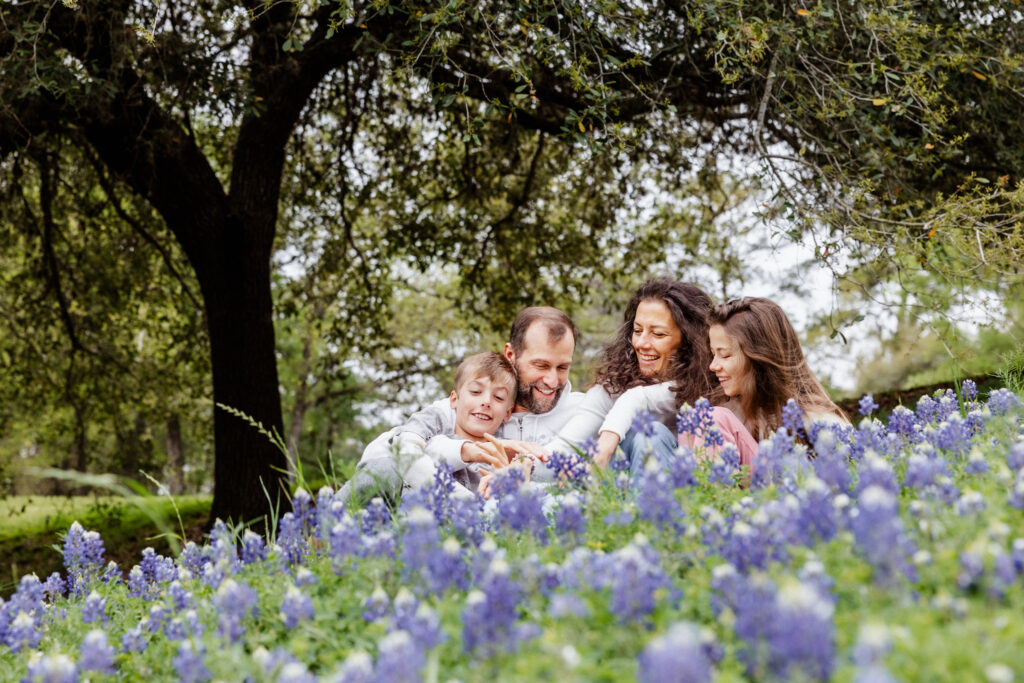 Family having fun during a bluebonnet mini session in Houston